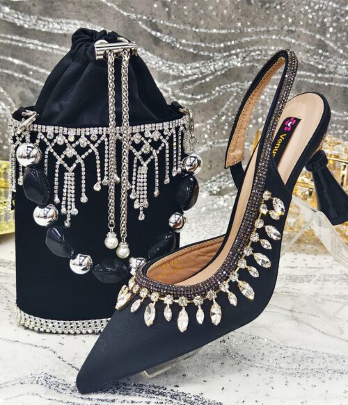 A pair of black satin slingback heels embellished with teardrop crystals, paired with a matching black velvet bag featuring crystal fringe and bold beads.