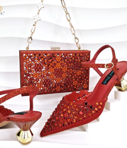 A pair of orange-red slingback heels with crystal embellishments and a matching rhinestone box clutch with a gold chain strap.